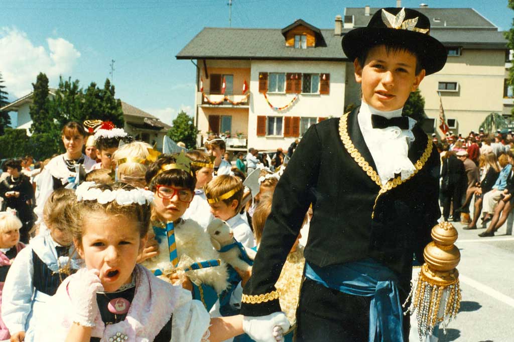 Der «tsanbri», mit dekoriertem Filzhut und Zepter, führt bei der Prozession die Kindergruppe an © Jean-Yves Glassey/Geschichtsmuseum Wallis, Sitten, 1990