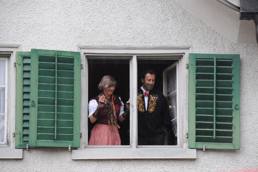 2011 Cantonal Assembly: Glarus residents in formal traditional dress at a window on Zaunplatz square, Glarus © Klara Hübner, 2011
