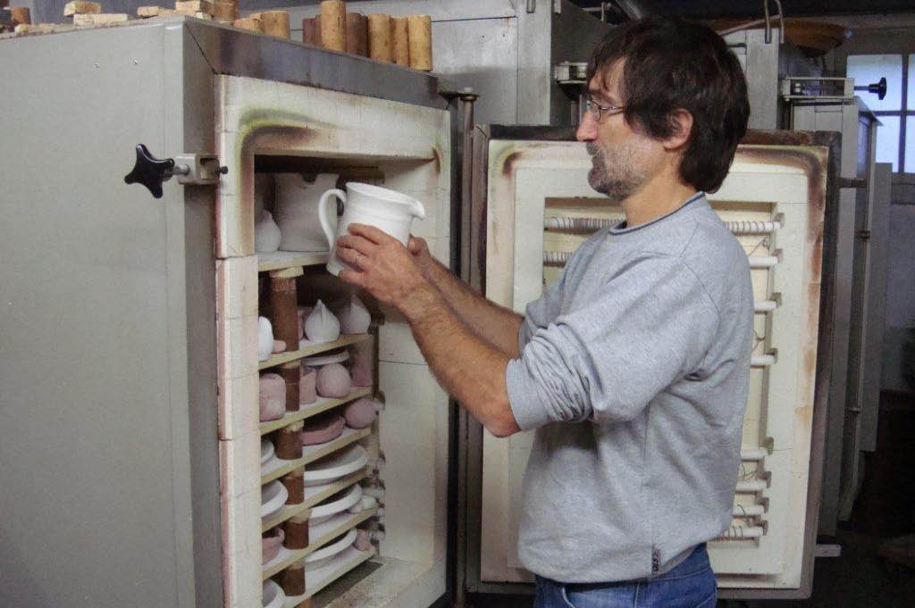 A potter carefully placing a jug in the kiln to be glost-fired © Töpferei Maurachern, Wichtrach, 2010