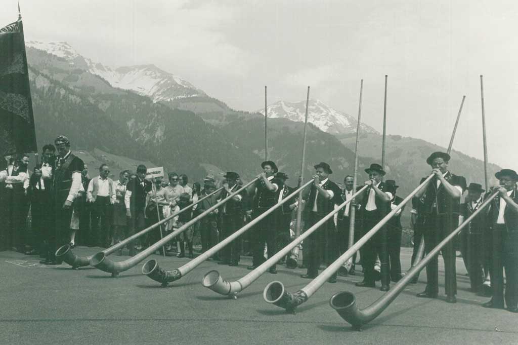Alphorn sextet performing, complete with scenic alpine backdrop © A. Hug, Frutigen