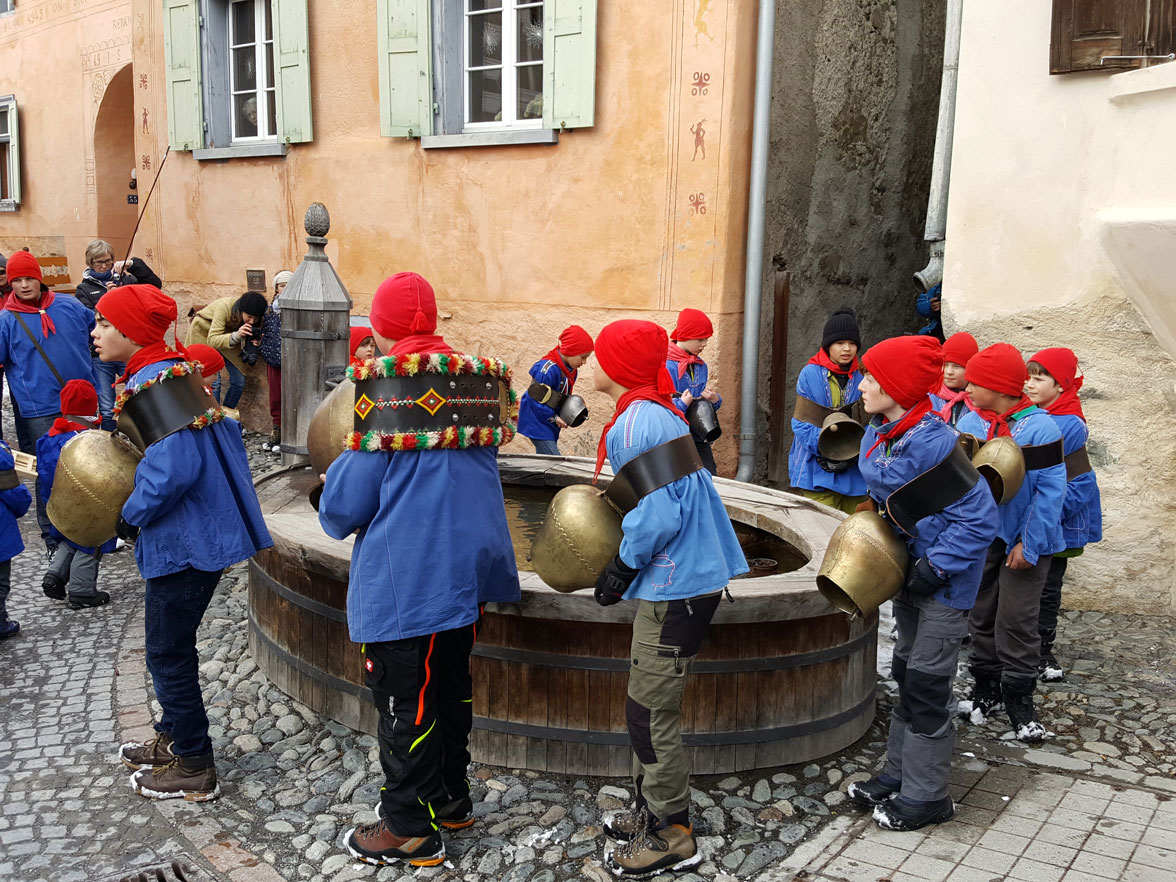 La sfilata intorno alla fontana (Guarda, 1.3.2017) © Scoula Scuol